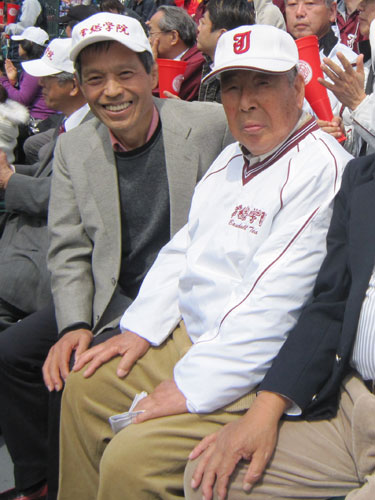 三塁側アルプス席で試合を観戦する常総学院・木内前監督（右）。左は丸山和也参議院議員