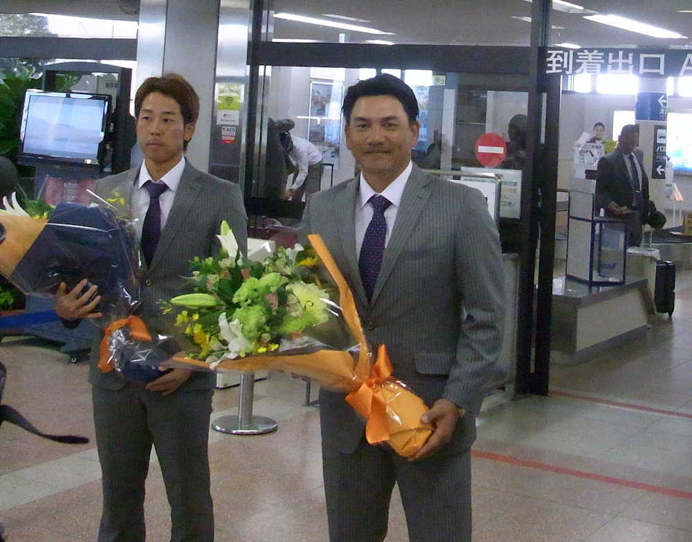 高知入りし、空港で花束を受け取るロッテ・井口監督（右）と鈴木　　