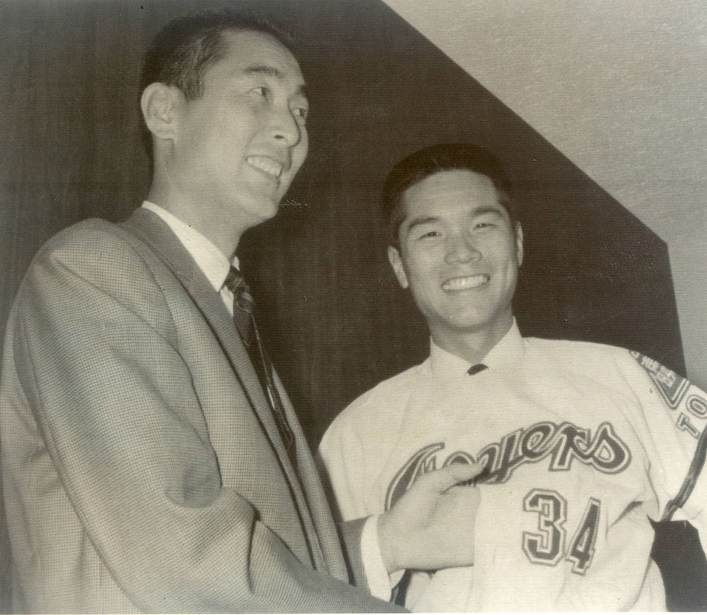 １９６８年１２月、東映入団が決まり、ユニホームを着る金田留広氏（右）と兄・正一氏