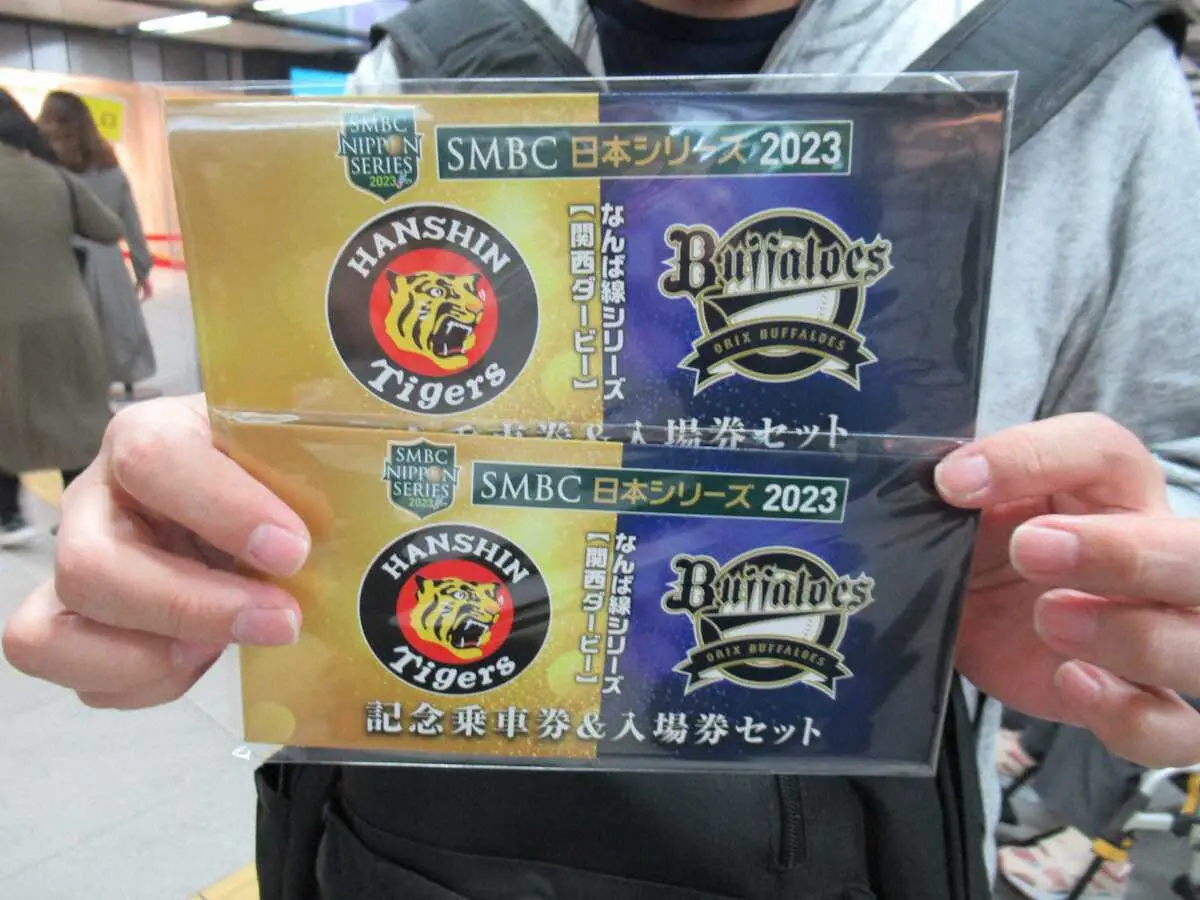 「なんば線シリーズ記念乗車券＆入場券セット」2セットを手に喜ぶ阪神ファン