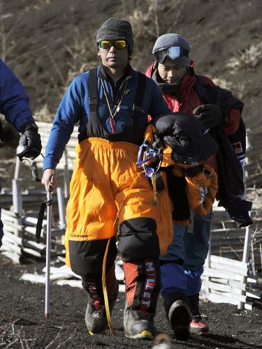 富士山で一時遭難、救助隊員と下山する元Ｆ１レーサーの片山右京さん（左）＝１８日午後１時３分、静岡県御殿場市