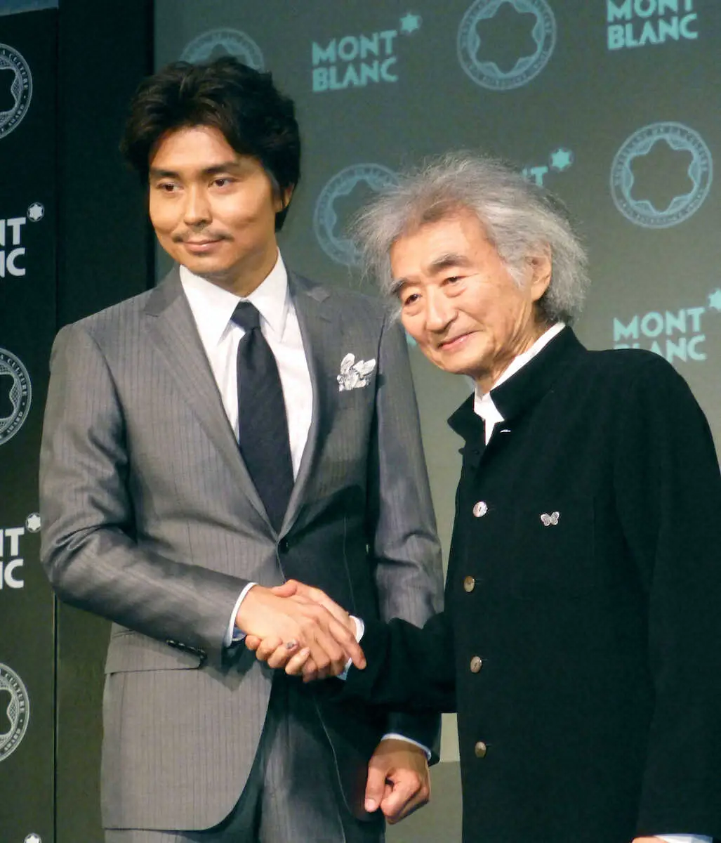 2014年5月、モンブラン国際文化賞を受賞した小澤征爾さん（右）と握手する長男の小澤征悦