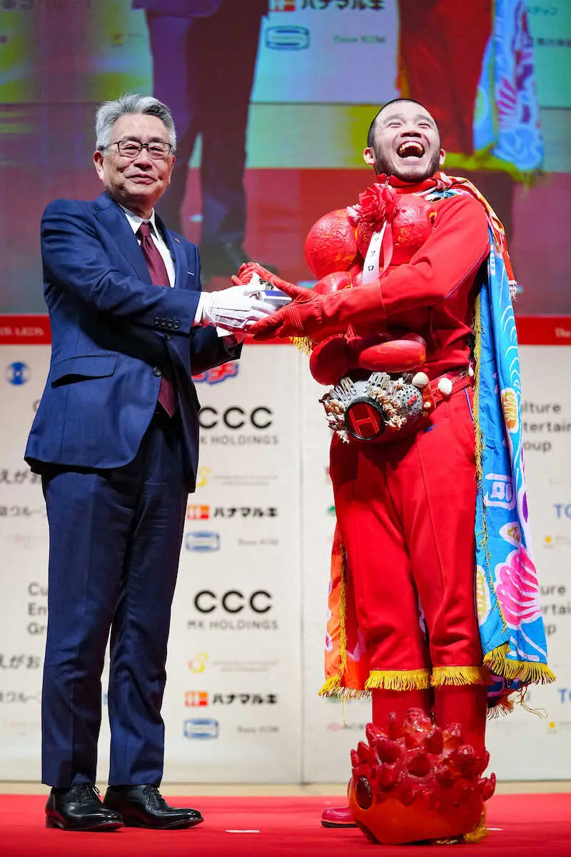 スポーツニッポン新聞社・小菅洋人社長（左）からトロフィーを贈られるアフロ（撮影・会津　智海）