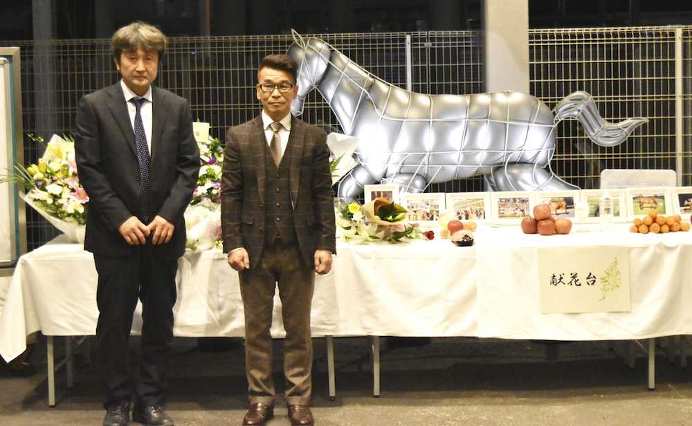 ロジータの献花台前に立つ野崎元騎手（右）と、管理した福島幸三郎元調教師の息子・秀夫調教師