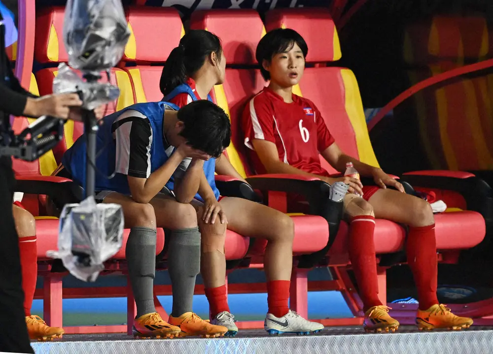 ＜アジア大会女子サッカー決勝　日本・北朝鮮＞後半、途中交代となりベンチで涙する北朝鮮代表GKキム・ウンヒ（左）（ロイター）