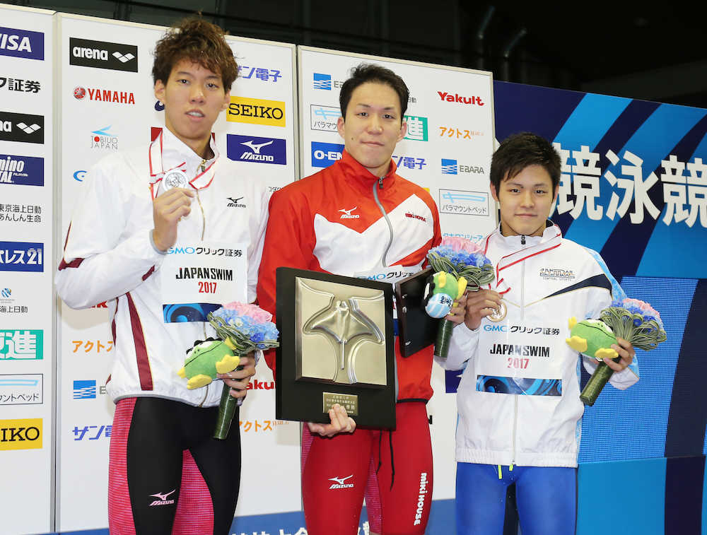 男子２００ｍ平泳ぎ決勝で優勝した小関也朱篤（中）は表彰台で記念撮影（左は渡辺一平）