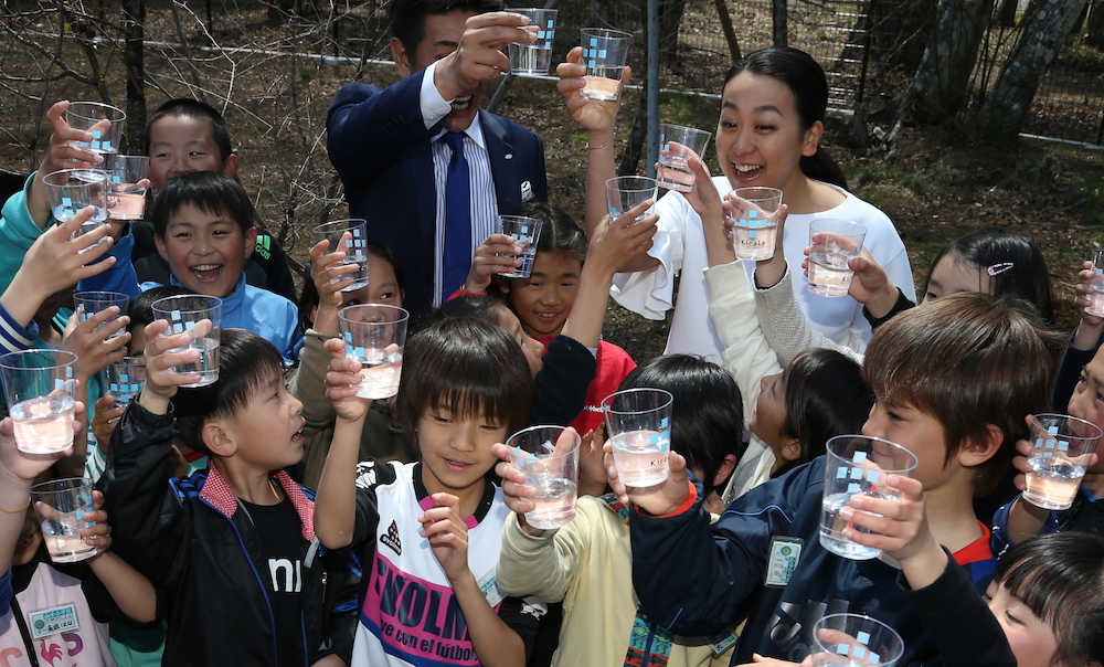 キララ富士山工場の敷地内にある源泉の水を子どもたちと一緒に飲む浅田真央さん