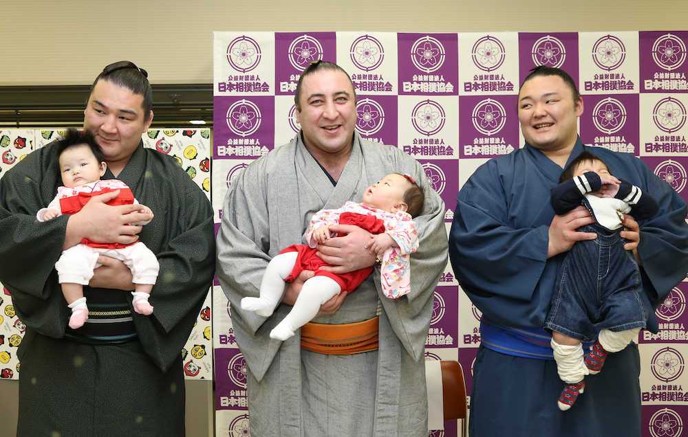赤ちゃんを抱っこするイベントで笑顔を見せる（左から）竜電、栃ノ心、朝乃山