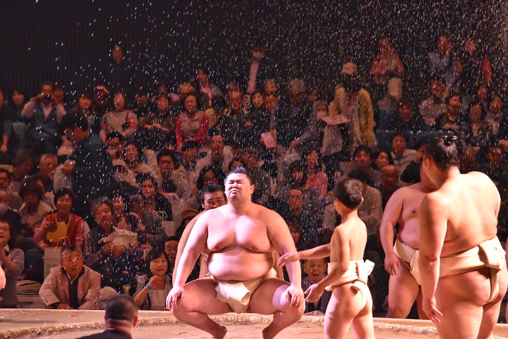 土俵がライトアップされる川崎場所。「ちびっこ相撲」で児童がまく塩も鮮明に映る