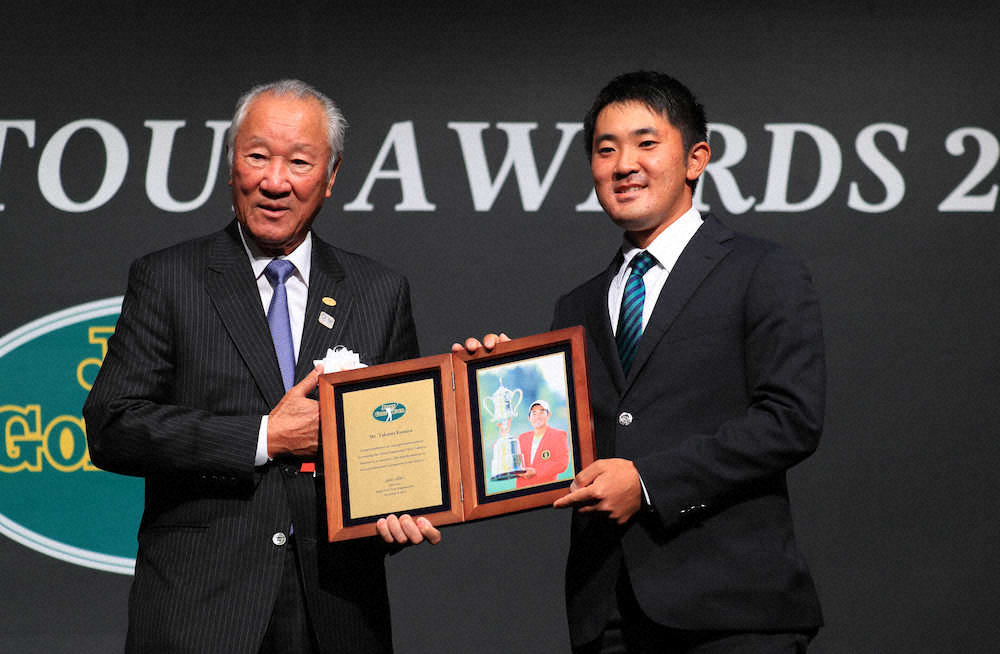 ＜ジャパンゴルフツアー表彰式＞特別賞を受賞し青木会長（左）から記念盾を贈られ笑顔の金谷（撮影・白鳥　佳樹）