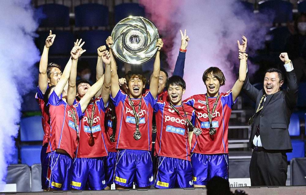 卓球Tリーグ・ファイナル　東京を破って初優勝し、シャーレを掲げて喜ぶ吉村真（前列左から3人目）ら琉球の選手。右端は張監督
