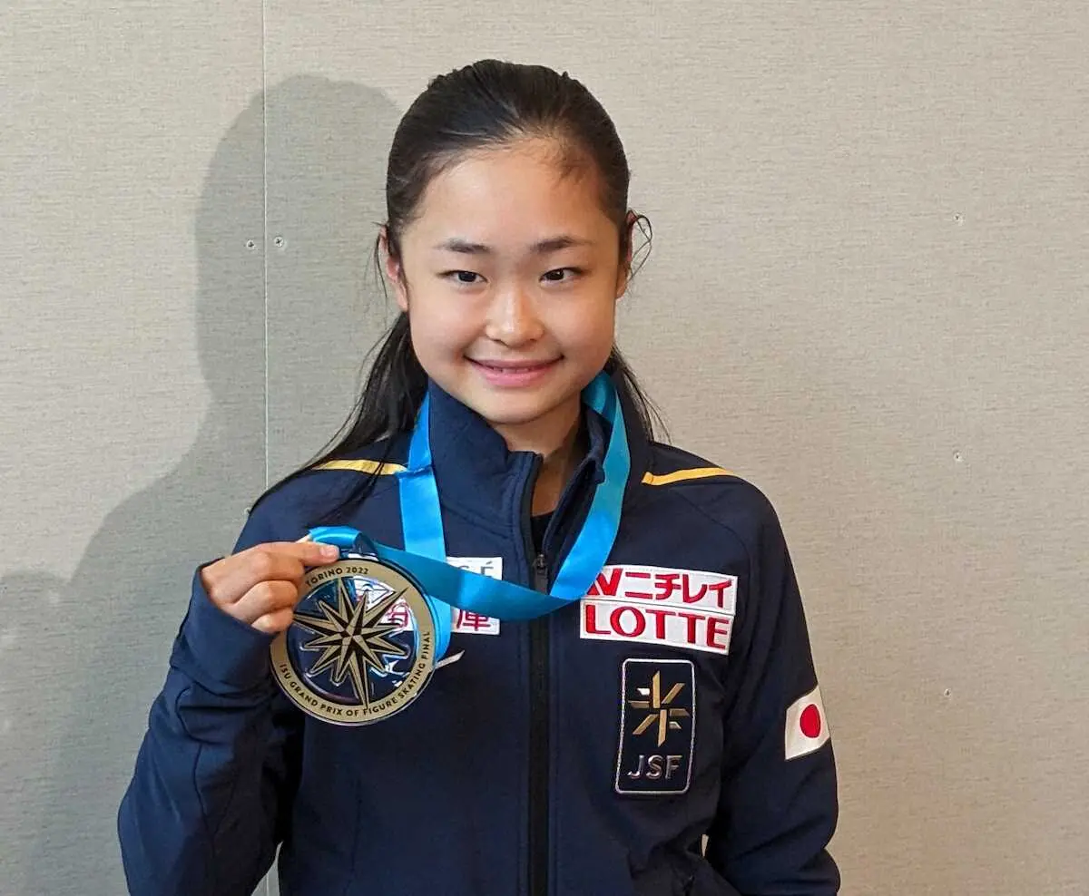 ジュニアGPファイナルを終えて羽田空港に帰国した島田麻央は金メダルを手に笑顔