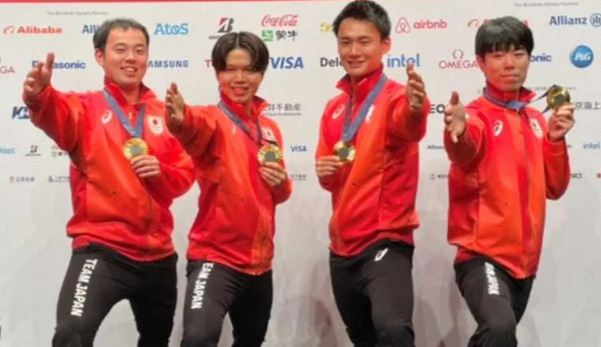一夜明け会見のフォトセッションで金メダルを手にフェンシングポーズを決める男子フルーレ団体の（左から）永野、飯村、松山、敷根